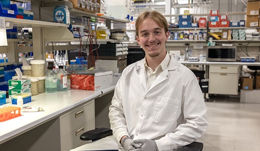 Graham Hartman smiling in his lab coat.
