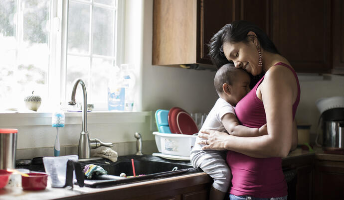 Woman holding baby in the kitchen