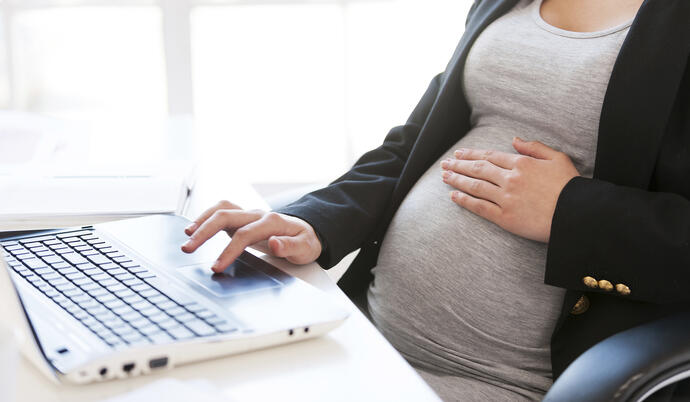 Pregnant woman on computer